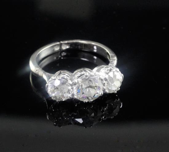 A mid 20th century white gold and three stone diamond ring, size closed, K.